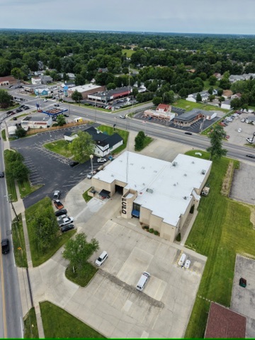 Drone view of a completed white roof over a commercial building