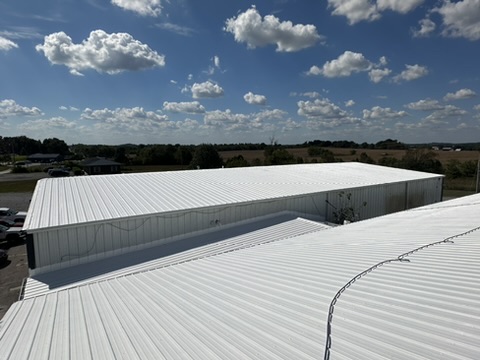 Metal roof after restoration with white reflective finish